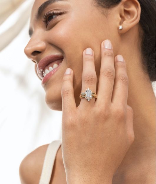 A woman wearing a vintage engagement ring with matching wedding band